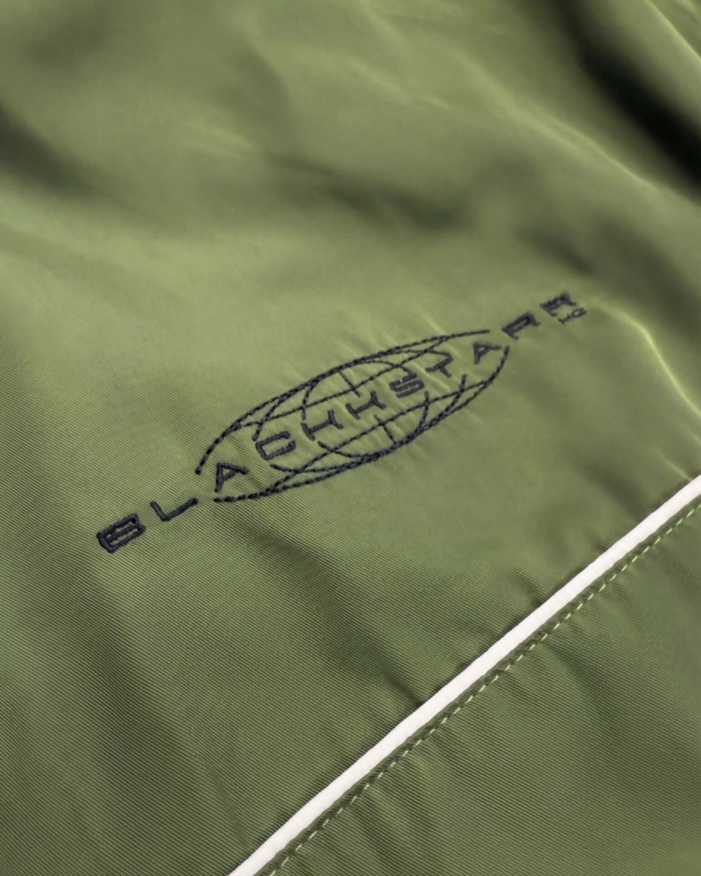 Green jacket with a brand logo on a white background