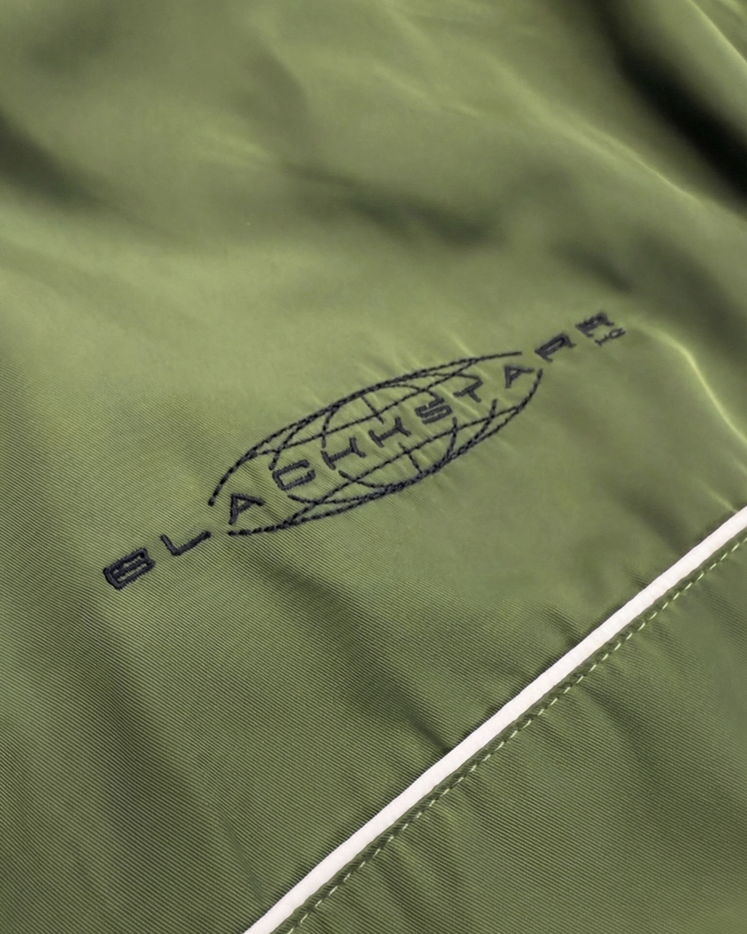 Green jacket with a brand logo on a white background